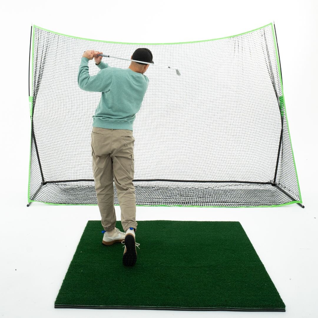 10' x 7' Golf net with golfer hitting on 5x5 golf mat