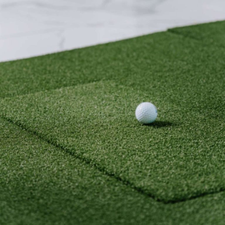 SIGPRO Softy hitting strip in mat with golf ball on top.
