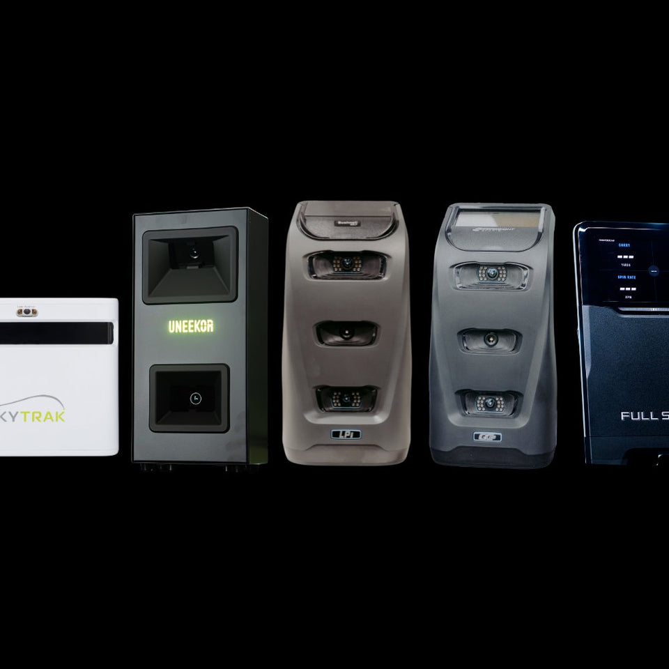 Square golf launch monitor on turf.