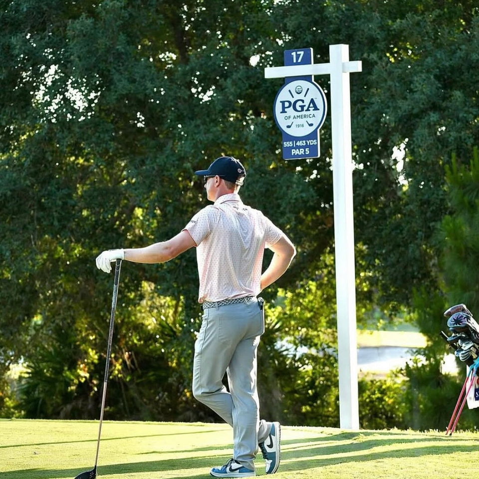 Square golf launch monitor on turf.