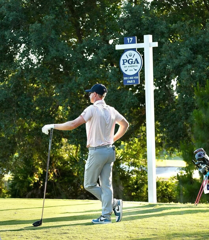 Square golf launch monitor on turf.