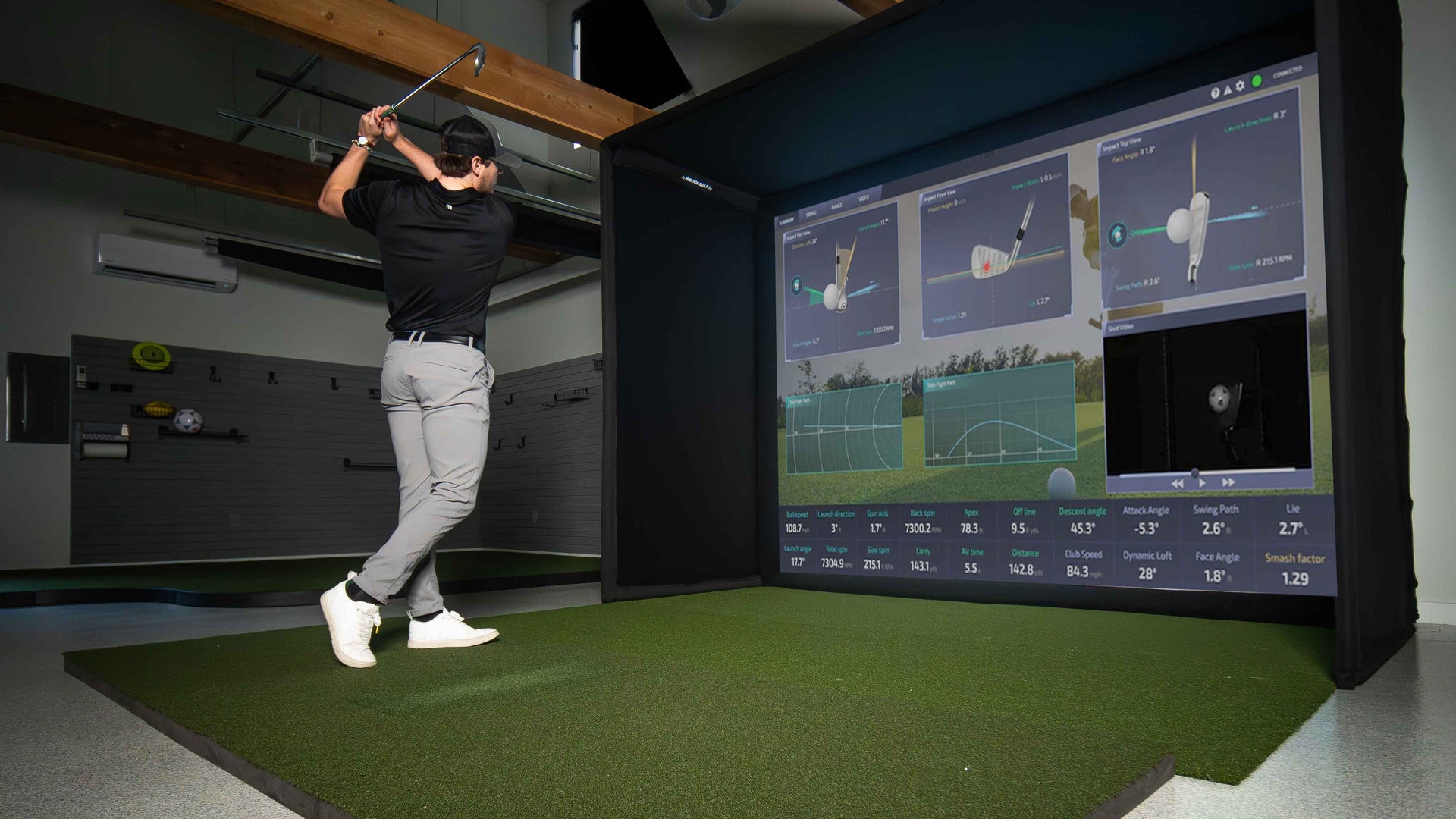 Square golf launch monitor on turf.