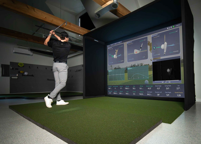 Square golf launch monitor on turf.