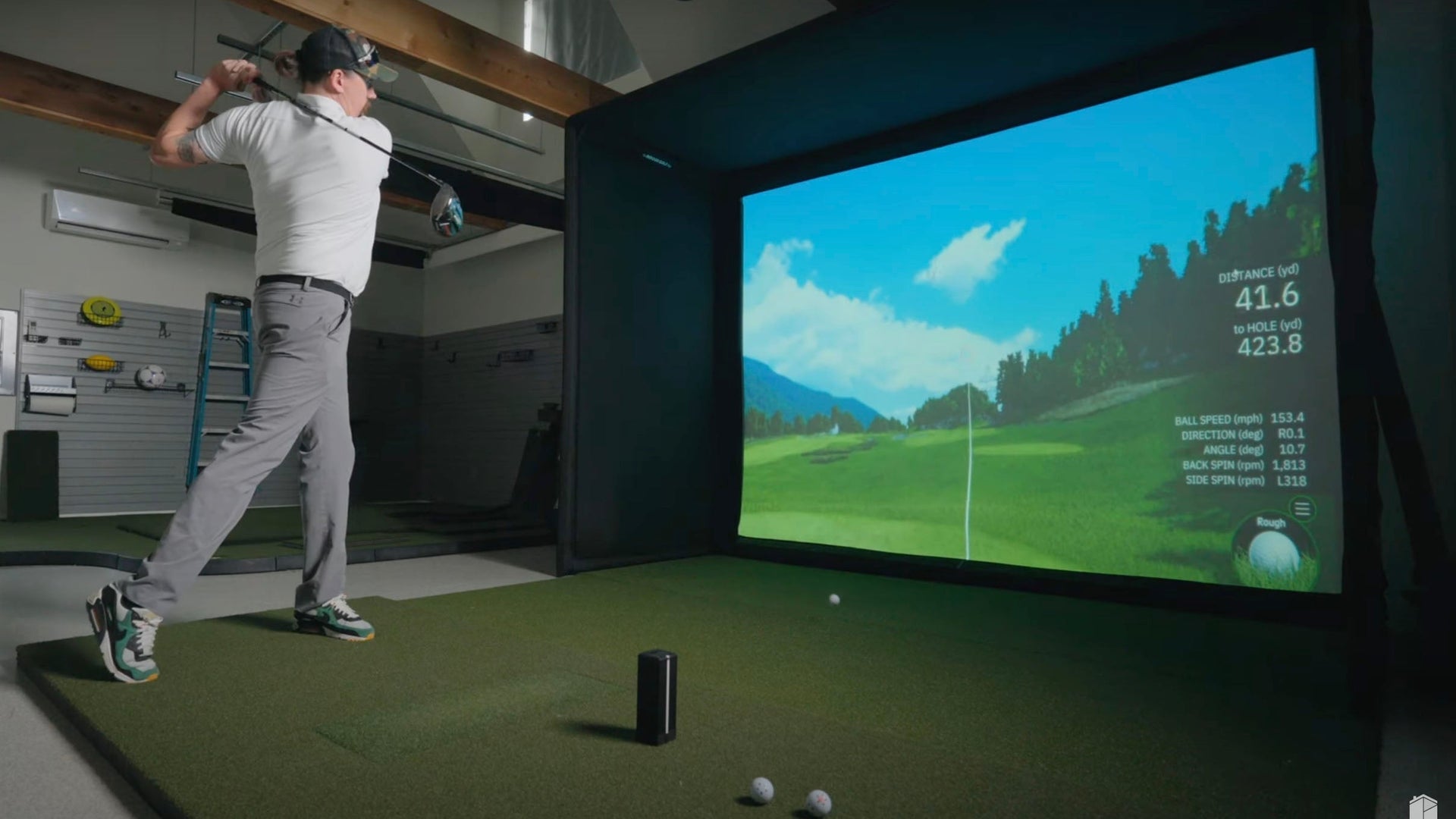 Square golf launch monitor on turf.