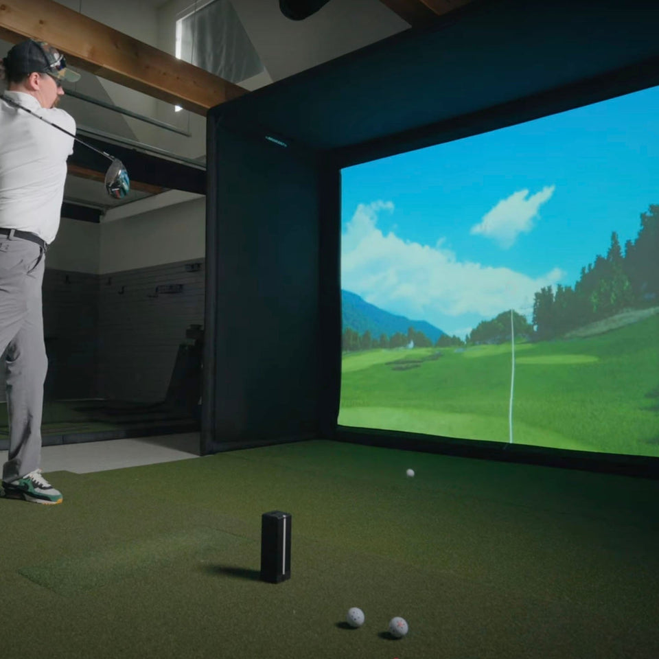 Square golf launch monitor on turf.