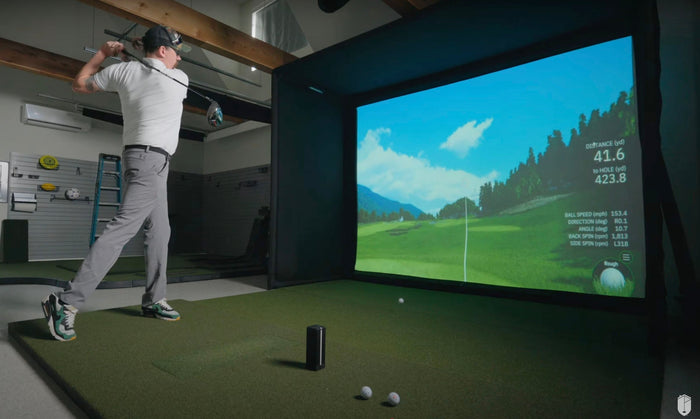 Square golf launch monitor on turf.