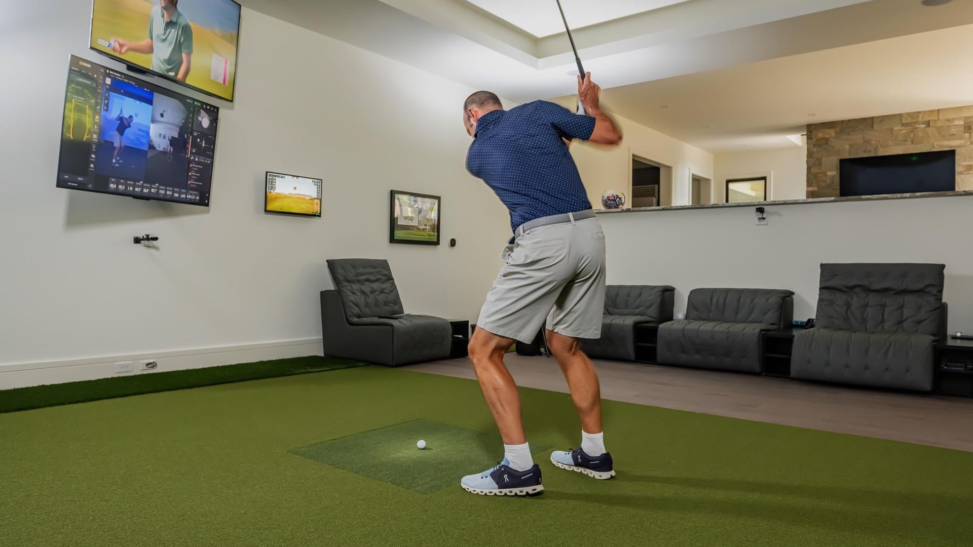 Square golf launch monitor on turf.