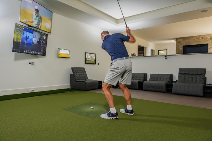 Square golf launch monitor on turf.