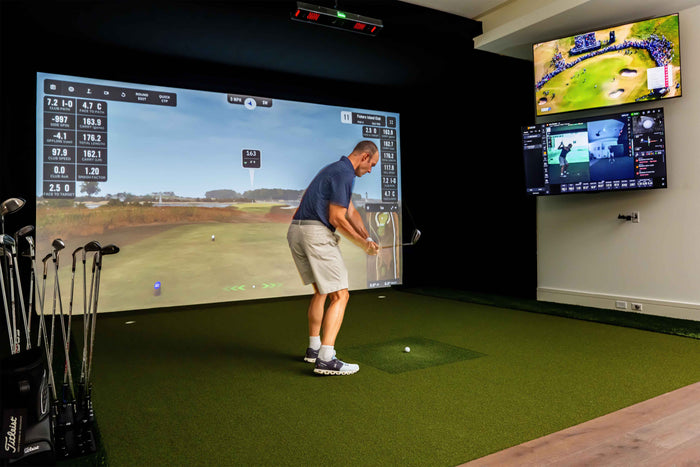 Square golf launch monitor on turf.