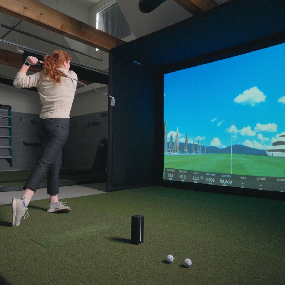 Image of a person using a golf simulator