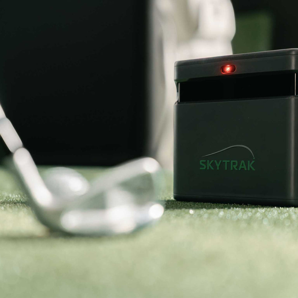 SkyTrak ST Max launch monitor on golf mat