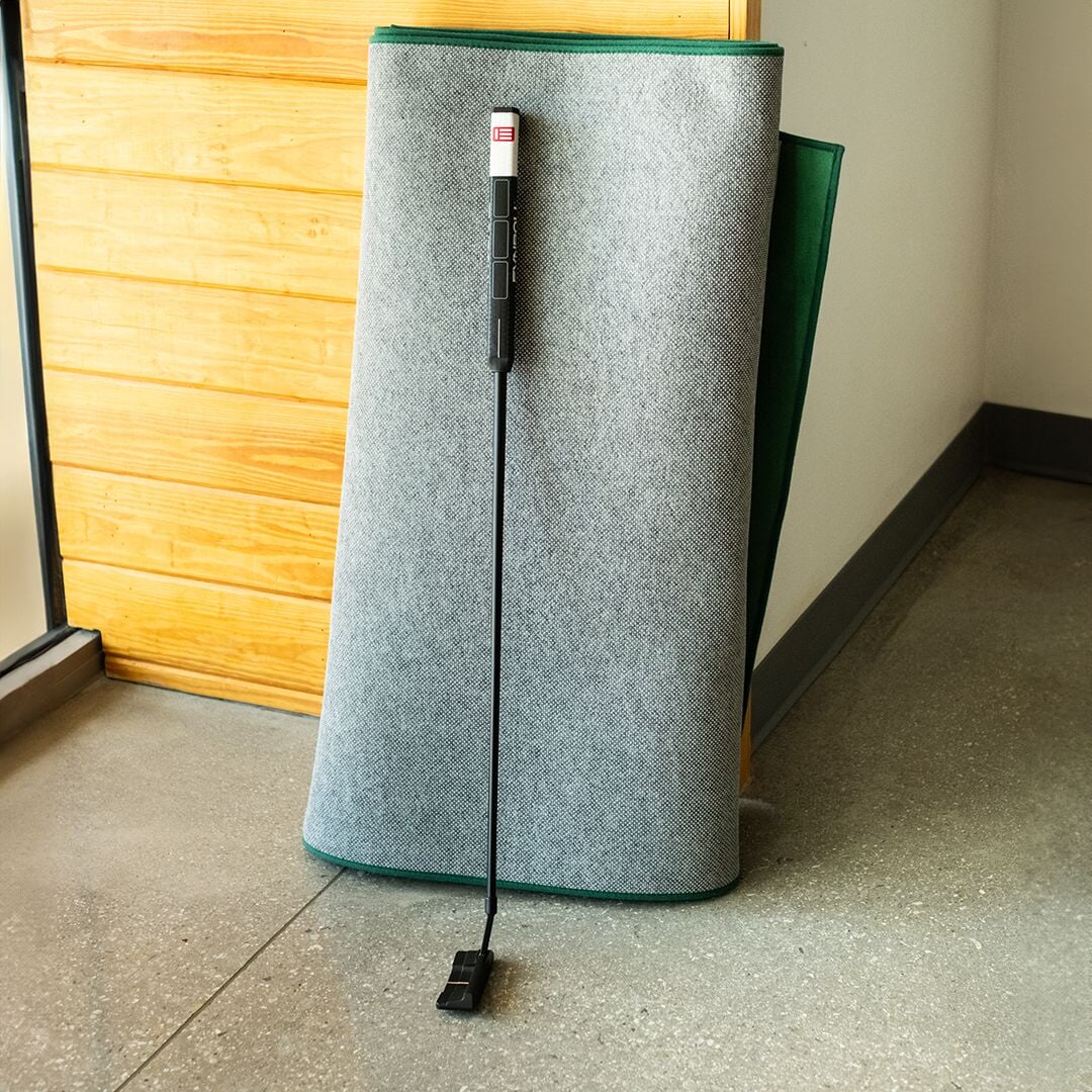 SIG LITE Indoor Putting Green 3' x 8' Green rolled up for storage