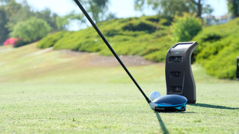 CG3 on course with driver and ball tee'd up in front of unit