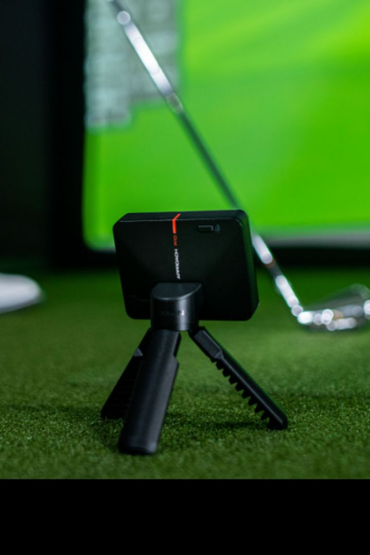 Garmin approach r10 with golfer and golf club in background