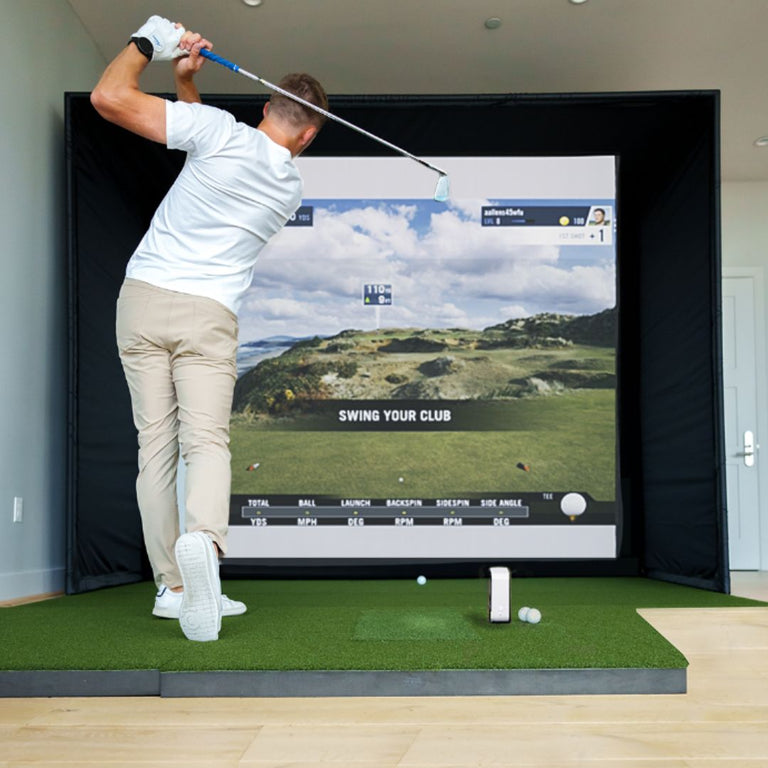 Golfer using skytrak launch monitor hitting on SIGPRO Softy 4' x 7' Golf Mat.