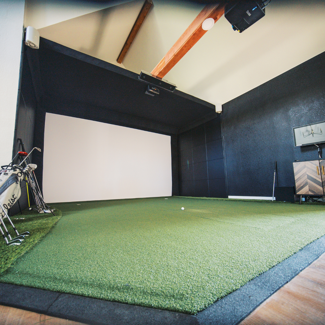 Custom Golf Simulator build in a home with launch monitor and projector mounted on beam.