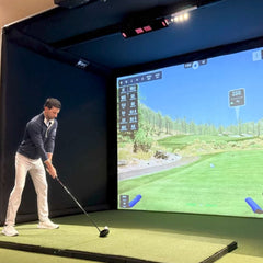 Commercial enclosure with golf simulator mounted to frame.