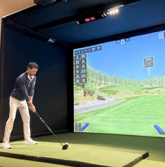 Commercial enclosure with golf simulator mounted to frame.