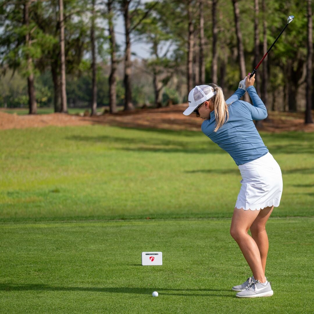 Grey FlightScope MEVO+ with golfer 