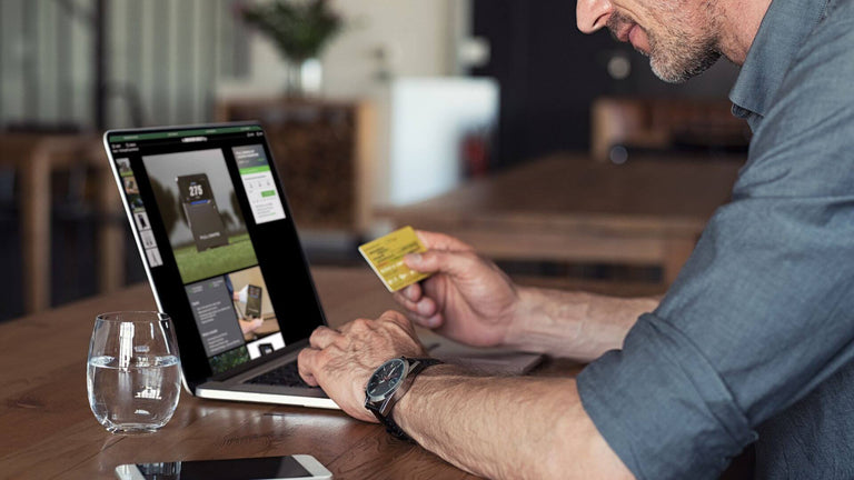 Man on laptop looking at The Indoor Golf Shop Website