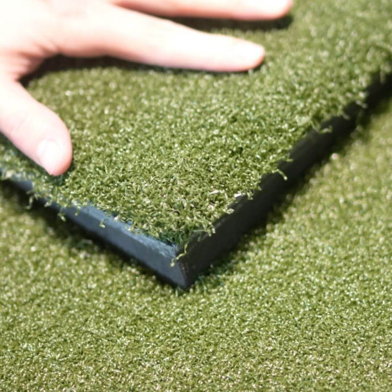 SIGPRO Softy Hitting Strip insert being pressed into golf mat