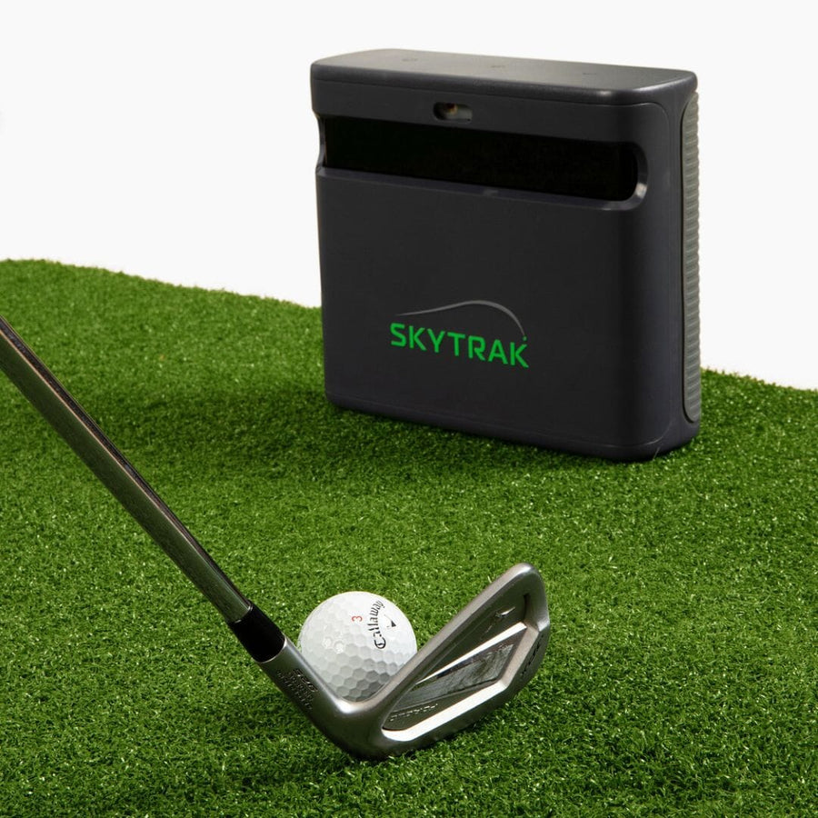 SkyTrak ST MAX launch monitor beside a golf iron