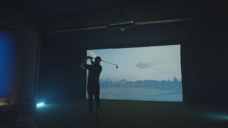 trugolf apogee mounted on ceiling with golfer finishing swing